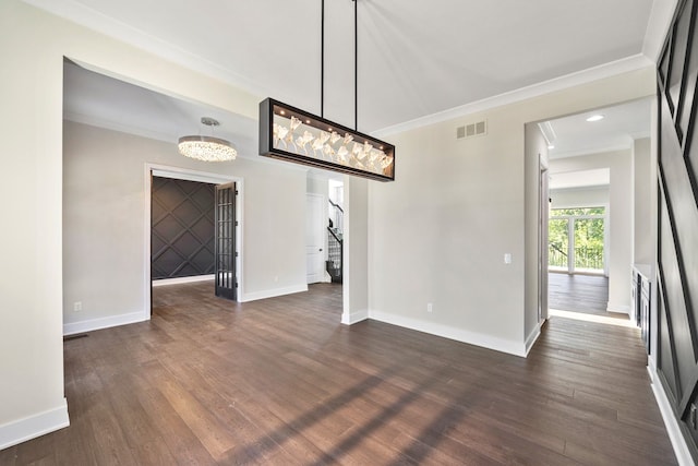 unfurnished dining area with a chandelier, dark wood-type flooring, and ornamental molding