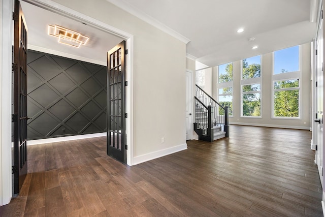 interior space featuring crown molding and dark hardwood / wood-style flooring