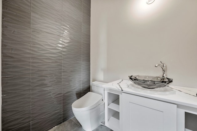 bathroom featuring tile patterned flooring, vanity, and toilet