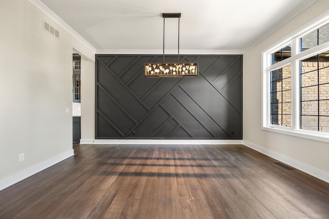 unfurnished dining area featuring dark hardwood / wood-style floors and ornamental molding