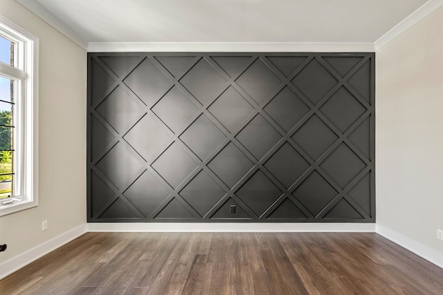 unfurnished room featuring ornamental molding, dark wood-type flooring, and a wealth of natural light