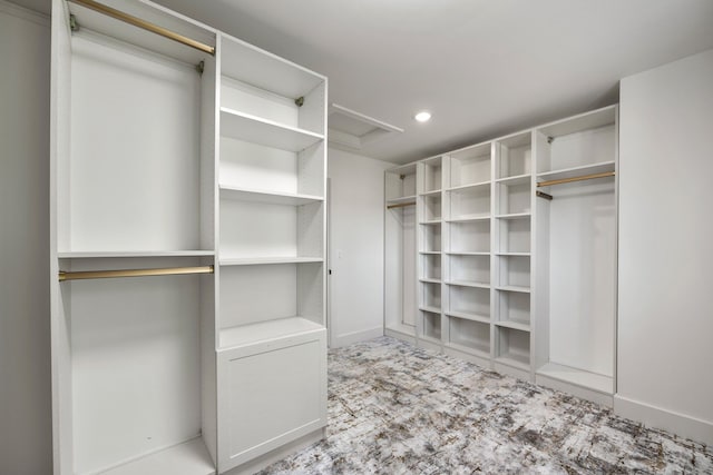 walk in closet featuring light colored carpet