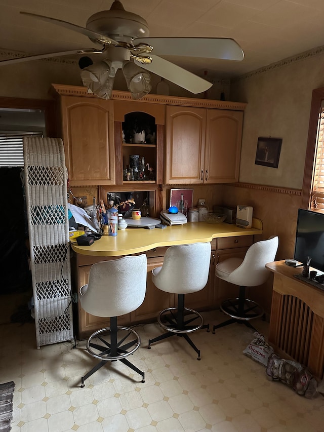 kitchen featuring a kitchen breakfast bar and ceiling fan