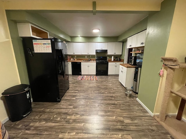 kitchen with sink, black appliances, butcher block countertops, white cabinetry, and dark hardwood / wood-style floors