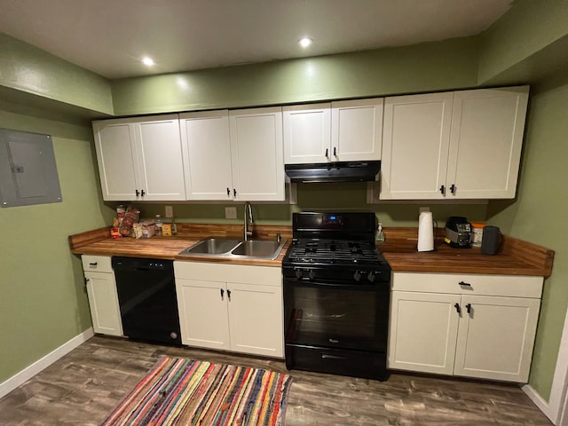 kitchen with butcher block counters, sink, electric panel, white cabinets, and black appliances