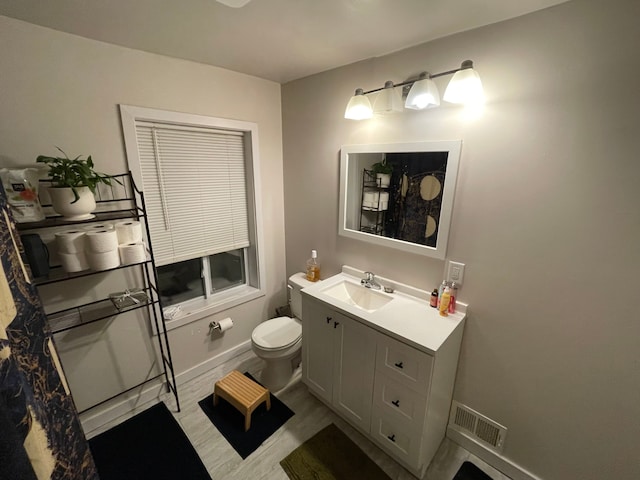 bathroom featuring vanity and toilet