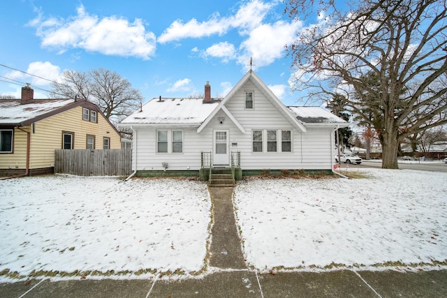 view of snow covered back of property