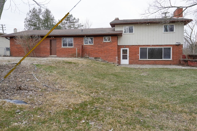 rear view of property featuring a lawn