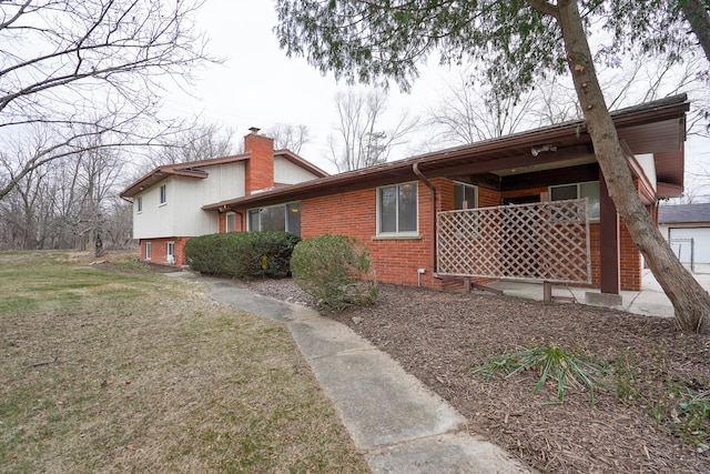 view of side of home featuring a lawn