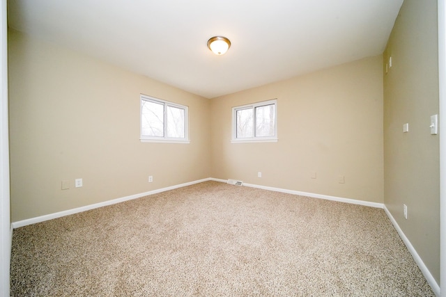 unfurnished room featuring carpet