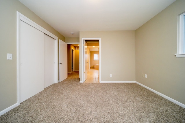 unfurnished bedroom with carpet flooring and a closet