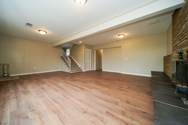 unfurnished living room featuring a fireplace and hardwood / wood-style flooring