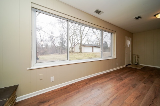 empty room with hardwood / wood-style flooring