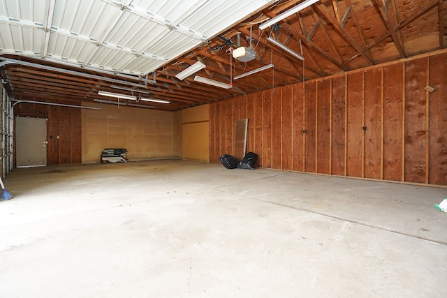 garage featuring wood walls and a garage door opener