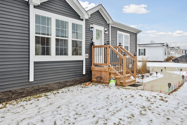 view of snow covered property entrance