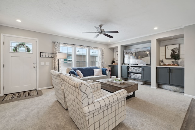 living room with a textured ceiling, light colored carpet, and ceiling fan