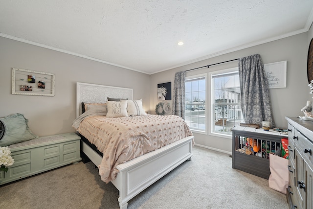 bedroom with a textured ceiling, light colored carpet, and ornamental molding