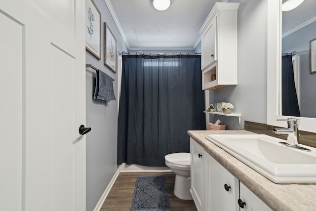 bathroom featuring vanity, wood-type flooring, a textured ceiling, and ornamental molding