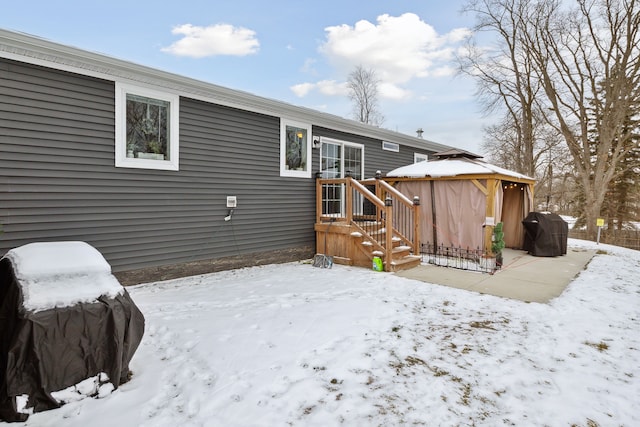 snow covered property with a gazebo