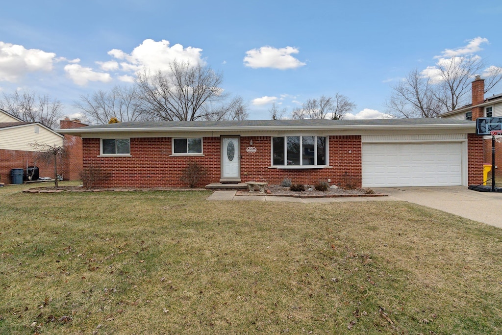 ranch-style house featuring a garage and a front yard