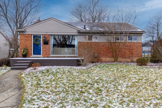 snow covered house with a yard