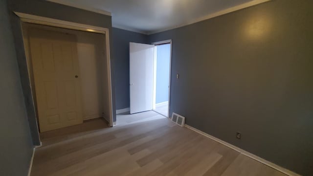 unfurnished bedroom with light hardwood / wood-style floors and a closet