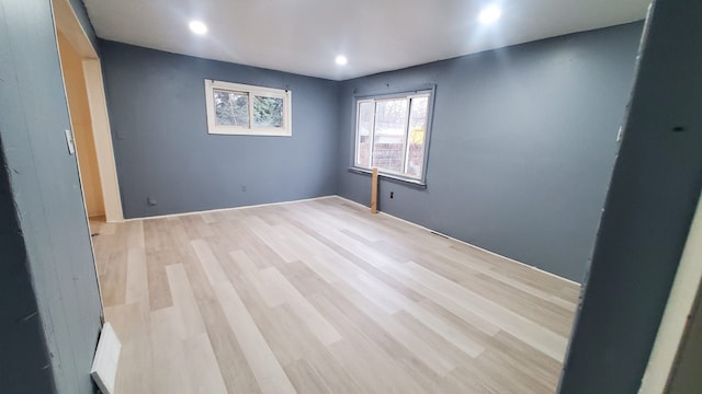 spare room with light hardwood / wood-style flooring