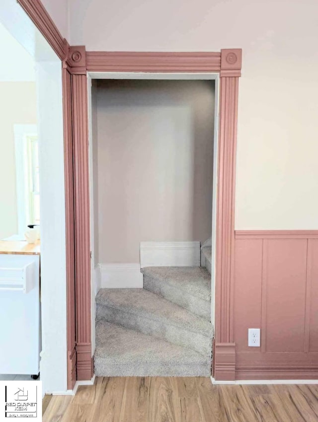 stairs featuring hardwood / wood-style floors