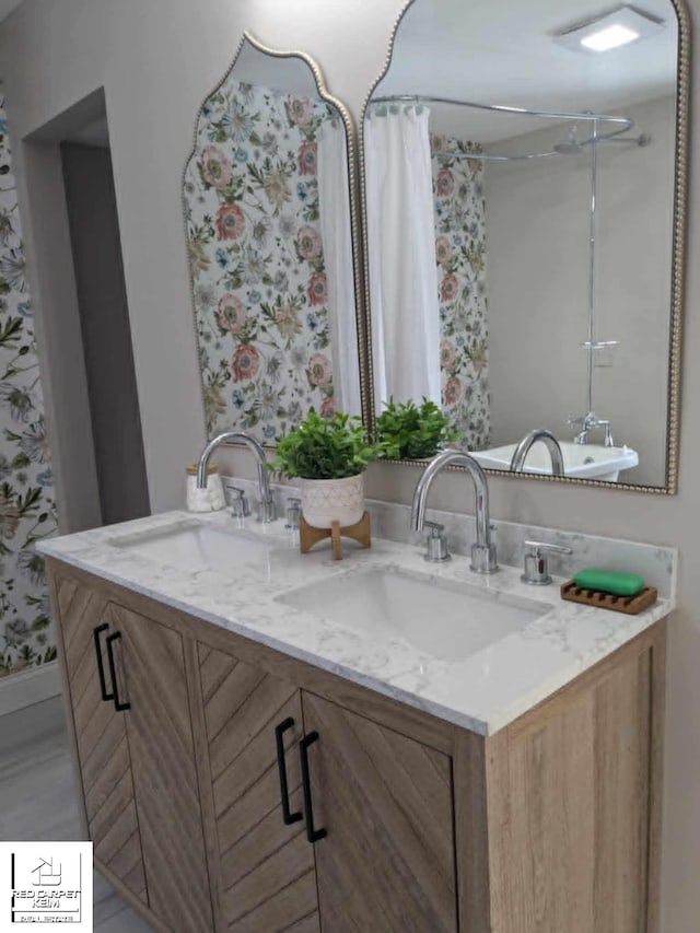 bathroom featuring a shower with curtain and vanity