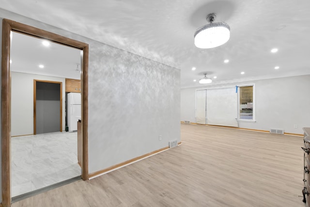 spare room featuring light wood-type flooring