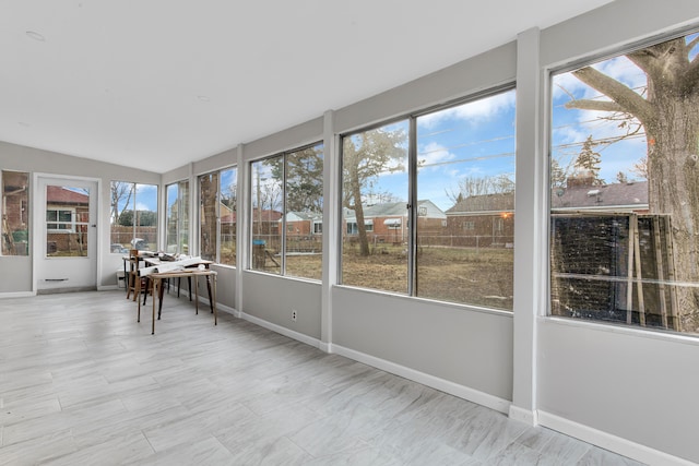 unfurnished sunroom with lofted ceiling