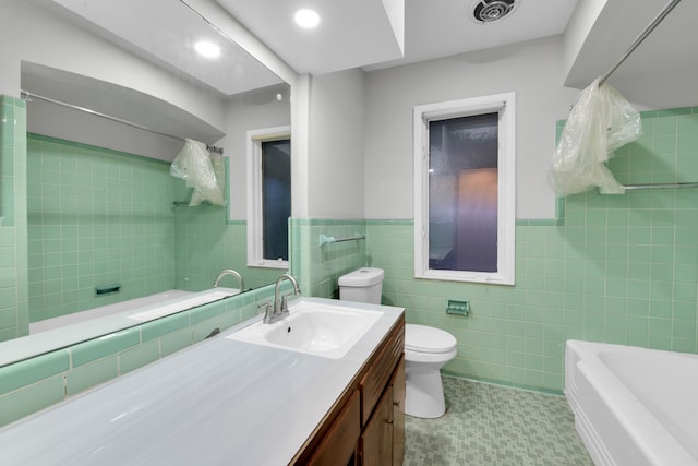 full bathroom featuring shower / tub combination, vanity, toilet, and tile walls