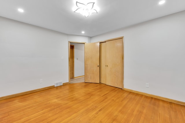 unfurnished bedroom featuring hardwood / wood-style floors and a closet