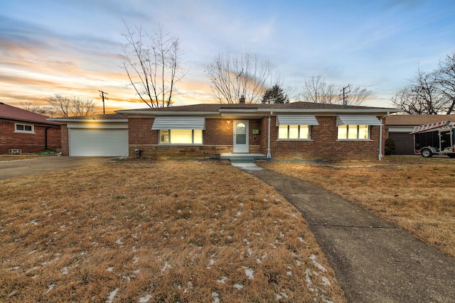 single story home with a lawn and a garage