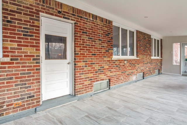 view of exterior entry with a porch