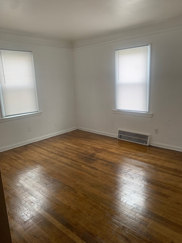 empty room featuring dark hardwood / wood-style flooring