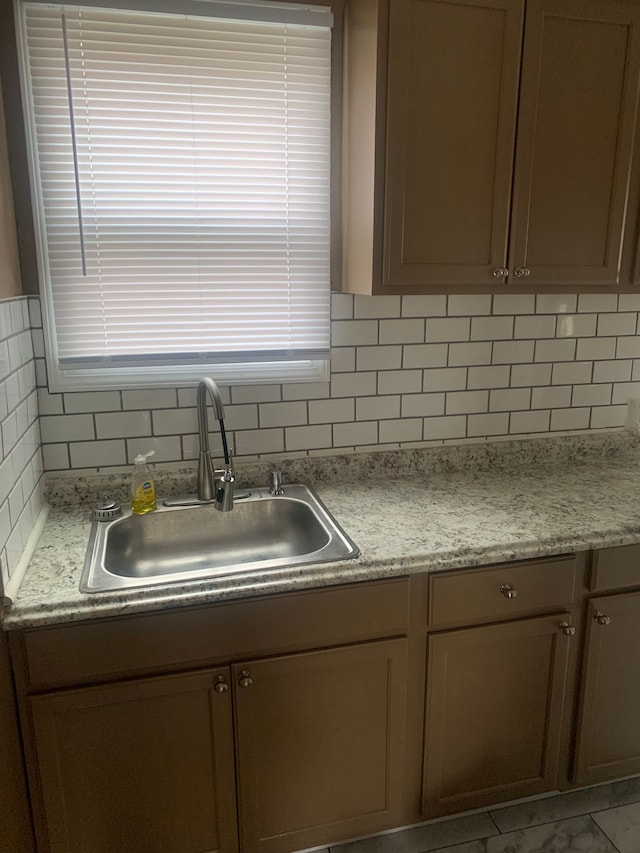 kitchen with tasteful backsplash and sink