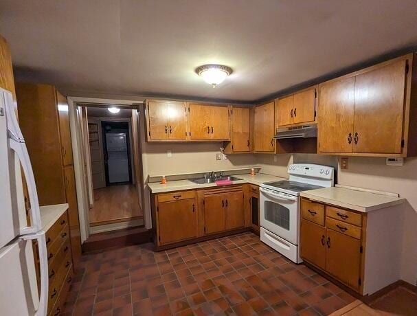 kitchen featuring white appliances and sink