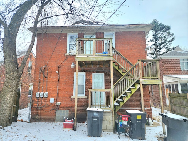 snow covered property featuring a balcony