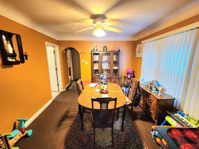 dining space with ceiling fan and carpet floors