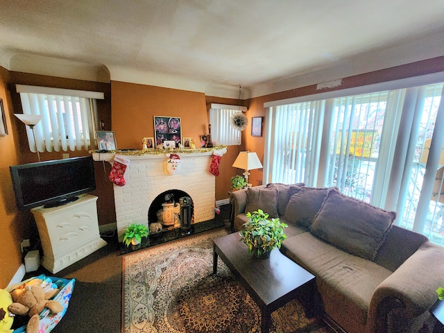 living room with a brick fireplace