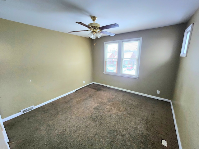 unfurnished room with ceiling fan and dark colored carpet