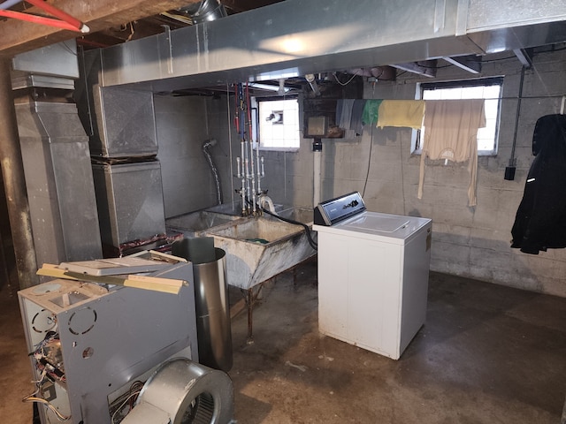 basement featuring washer / clothes dryer, a wealth of natural light, and sink