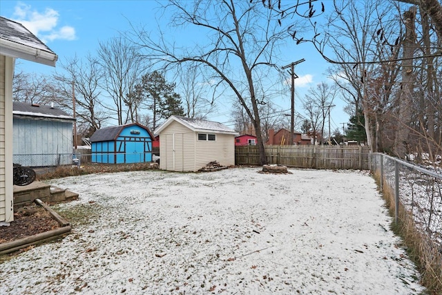 snowy yard with a fire pit and a shed