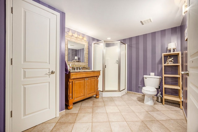 bathroom featuring tile patterned floors, vanity, toilet, and an enclosed shower