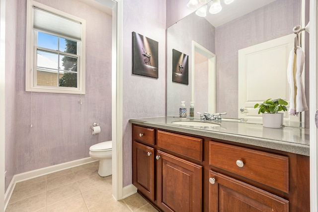 bathroom with tile patterned flooring, vanity, and toilet