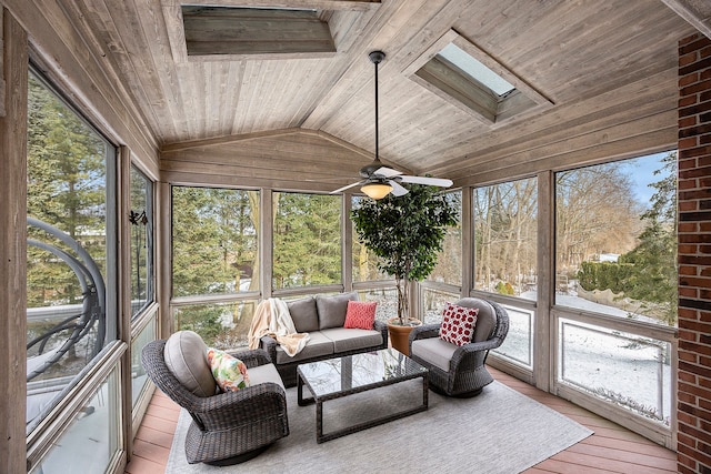 sunroom / solarium featuring a wealth of natural light, lofted ceiling with skylight, ceiling fan, and wood ceiling