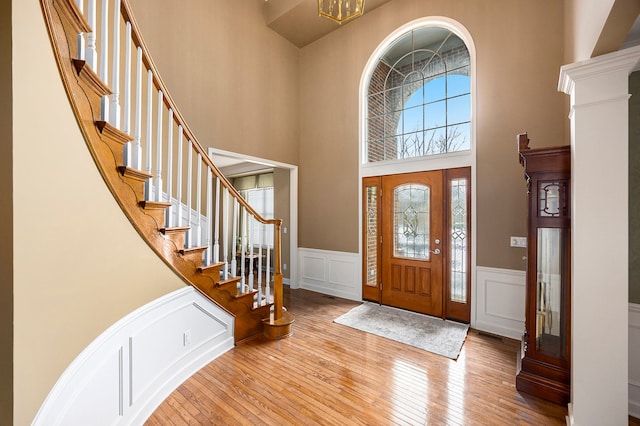 entryway featuring a high ceiling and light hardwood / wood-style flooring