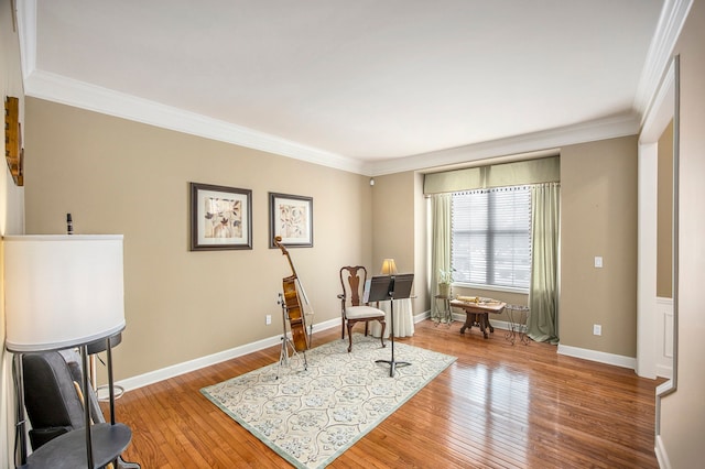 living area featuring crown molding and wood-type flooring