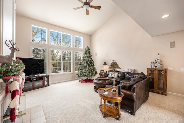 living room with ceiling fan, high vaulted ceiling, and light colored carpet